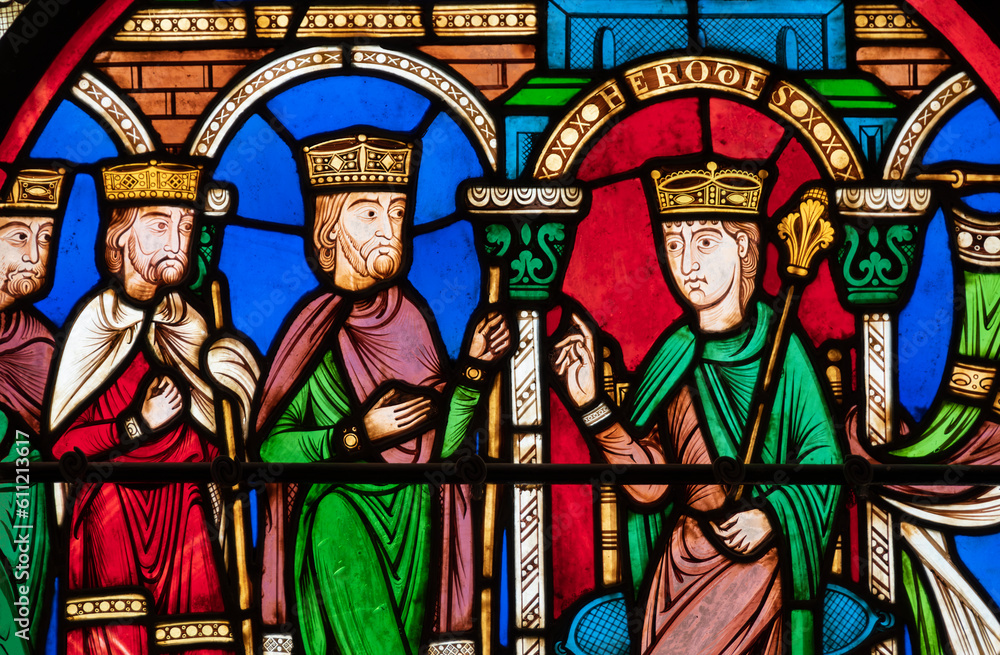close up detail of stained glass panel showing four kings in colorful robes from St. Denis Basilica in Paris, France