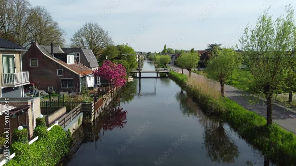 Aerial push in view of Corversbrug with beautiful trees, houses, and lake in the Netherlands Aerial push in view of Corversbrug with beautiful trees, houses, and lake in the Netherlands