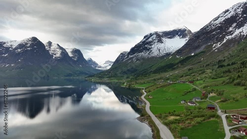 Oppstrynsvatnet lake close to mountains containing the Jostedal Glacier - Downward moving summer aerial with mountain reflections in the lake - Road RV 15 leading to Strynefjell mountain crossing photo