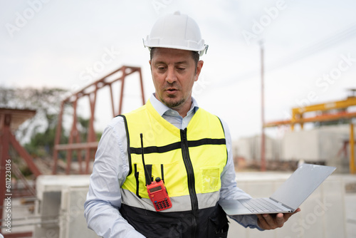 Portrait caucasian engineer man working with notebook computer at precast site work 