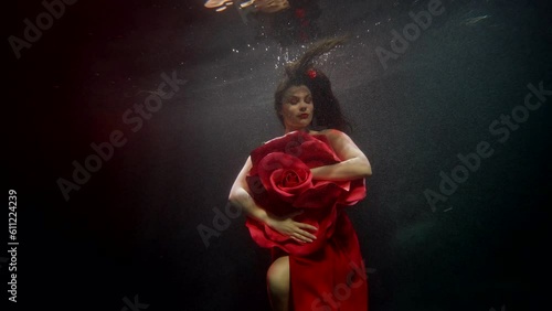 amazing female beauty and femininity, underwater shot with attractive brunette woman