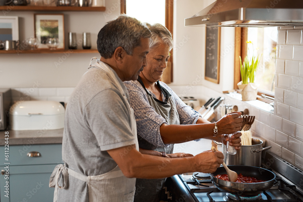 Cooking food, help and old couple in kitchen with smile, meal prep and frying at stove together. Love, senior woman helping elderly man prepare lunch in pan, retirement and dinner time in modern home Cooking food, help and old couple in kitchen with smile, meal prep and frying at stove together. Love, senior woman helping elderly man prepare lunch in pan, retirement and dinner time in modern home