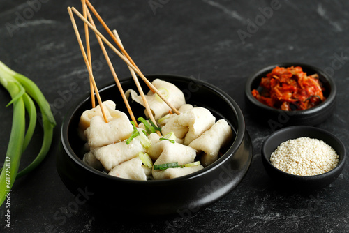 Korean Odeng Tangeomuk Odeng Guk, Korean Fish Cake Soup in Traditional Pot on Black Table Background