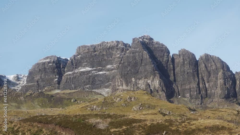 The Trotternish Ridge displaying it's epic rocky formations and blue skies in the Isle of Skye The Trotternish Ridge displaying it's epic rocky formations and blue skies in the Isle of Skye