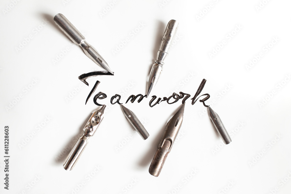 teamwork word hadwritten with multiple pen nibs on white paper, teamwork word hadwritten with multiple pen nibs on white paper,