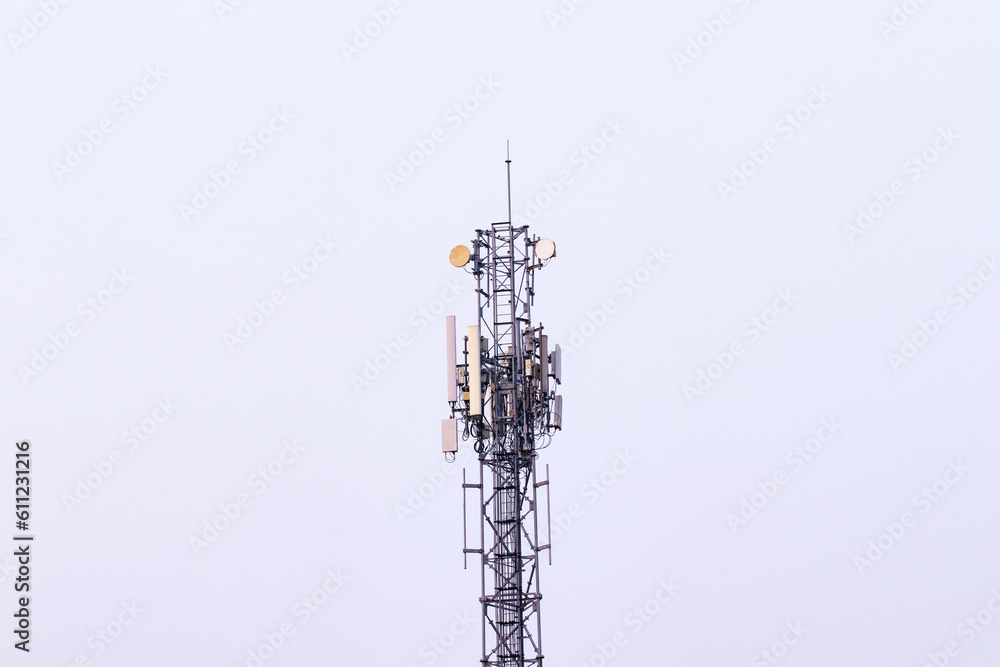 Telecommunication tower. Wireless Communication Antenna Transmitter with antennas bright sunlight and sky background. tower 4G, 5G cellular Base Station or Base Transceiver Station future technology. Telecommunication tower. Wireless Communication Antenna Transmitter with antennas bright sunlight and sky background. tower 4G, 5G cellular Base Station or Base Transceiver Station future technology.