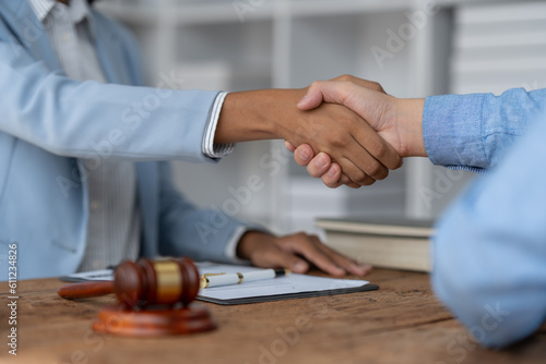 American businesswoman or lawyer African handshake with real estate agent in contract signing agreement Joint venture financial contract documents concept of legal services, justice.