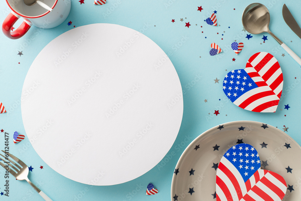Obraz premium Prepare for Independence Day USA with unique table setting. Top view of symbolic decorations, a plate, utensils, cup, and other on pastel blue backdrop, empty circle for text or promotional content
