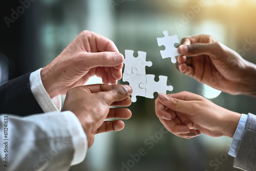 Puzzle, business hands and group of people for solution, teamwork and goals, integration or workflow success. Team building, games and development of person problem solving, synergy or collaboration photo