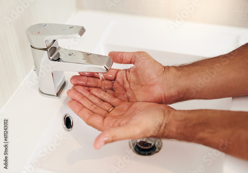 Tap, water and person cleaning hands for skincare, personal grooming and safety of bacteria, healthy and dermatology. Closeup, palm and washing hand at basin in bathroom for hygiene routine at home