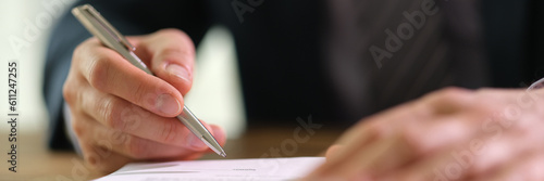 Businessman signing document contract with ballpoint pen in office closeup. Formal employment and contract agreements concept