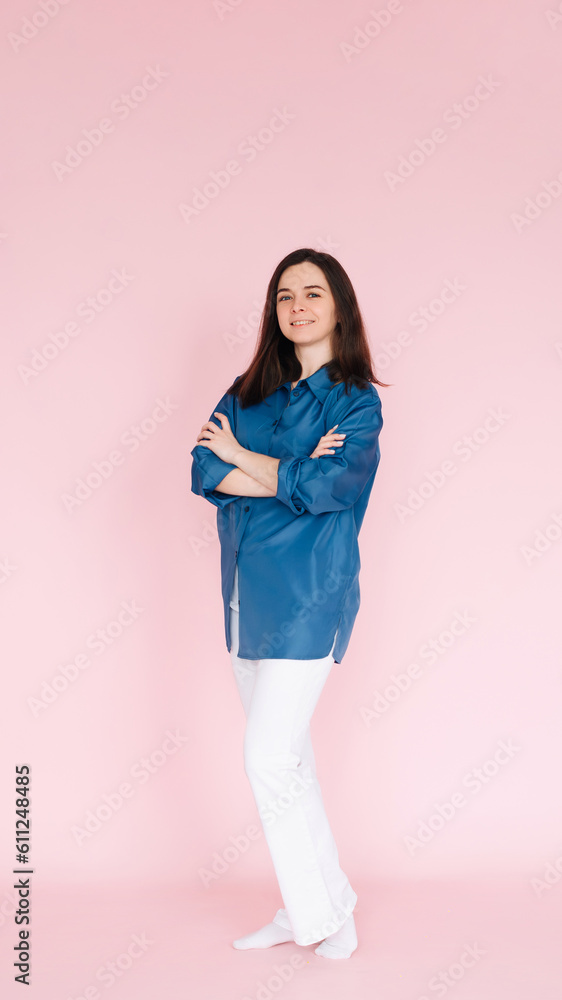 Portrait of professional businesswoman in smart casual attire standing confidently with folded hands, isolated on a pink background. Portrait of professional businesswoman in smart casual attire standing confidently with folded hands, isolated on a pink background.
