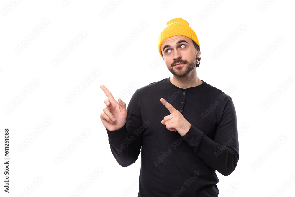 brutal 30s authentic brunet male adult in black sweatshirt pointing finger at new strategy on white background with copy space brutal 30s authentic brunet male adult in black sweatshirt pointing finger at new strategy on white background with copy space
