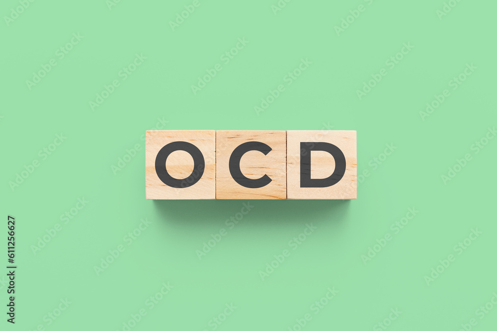 OCD (Obsessive-Compulsive Disorder) wooden cubes on green background OCD (Obsessive-Compulsive Disorder) wooden cubes on green background