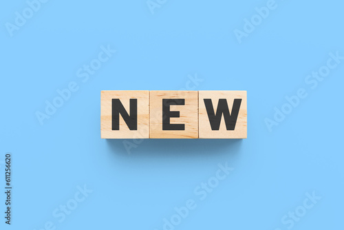 New wooden cubes on blue background