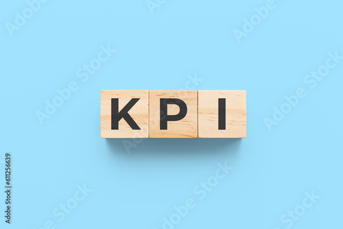 KPI (key performance indicator) wooden cubes on blue background