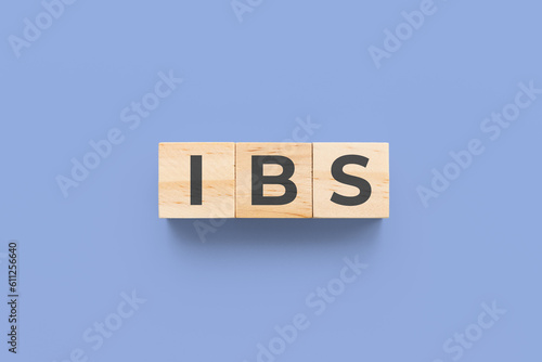 IBS (Irritable Bowel Syndrome) wooden cubes on blue background