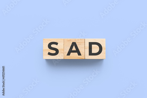 SAD (Social Anxiety Disorder) wooden cubes on blue purple background