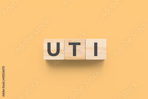 UTI (Urinary Tract Infections) wooden cubes on orange background