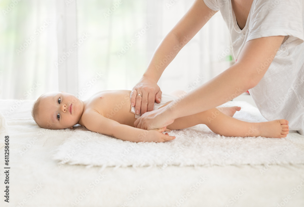 Mommy changing diaper her adorable baby Mommy changing diaper her adorable baby