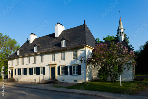 The 18th Century Mauvide-Genest manor with small chapel seen from the street in spring, Saint-Jean, Island of Orleans, Quebec