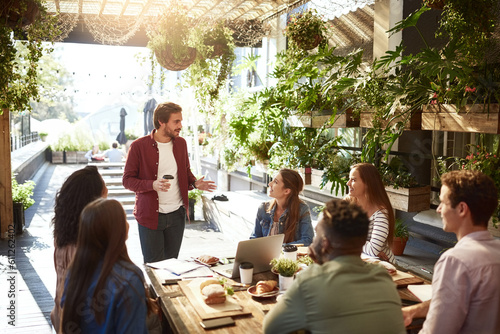 Presentation, restaurant and business people in meeting for discussion, planning and communication. Coffee shop, teamwork and men and women talking for team building, collaboration and project ideas