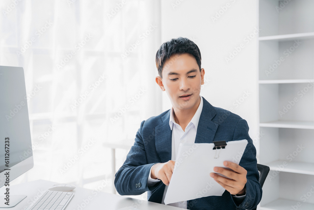 Business man working at office with laptop and documents on his desk, financial adviser analyzing data. Business man working at office with laptop and documents on his desk, financial adviser analyzing data.