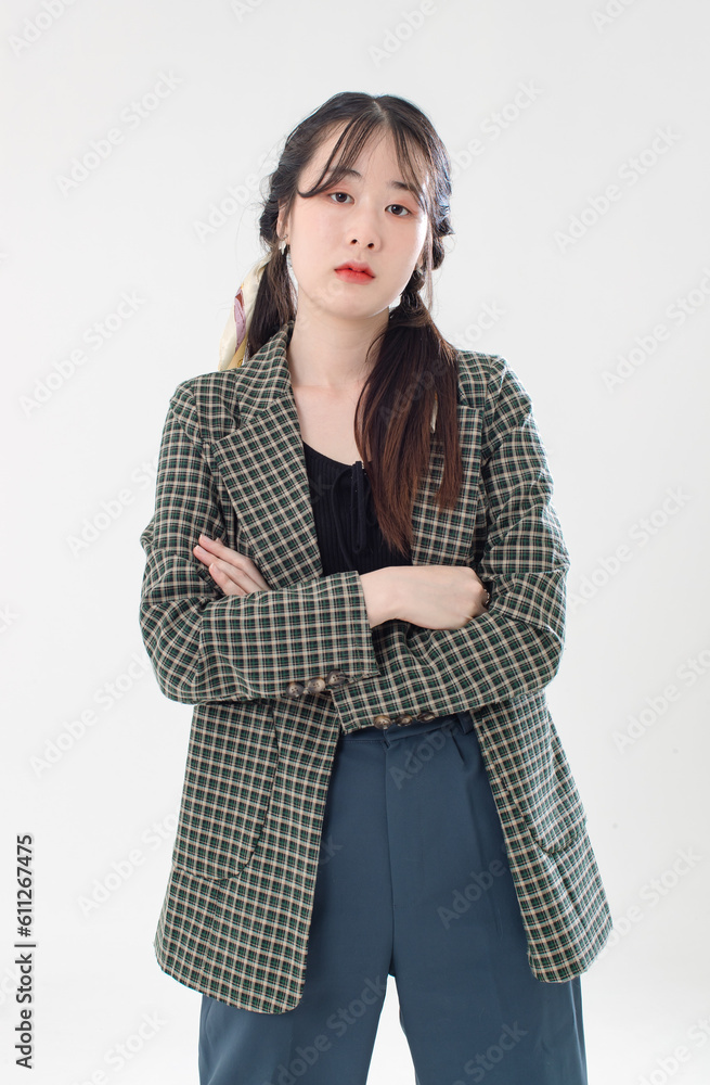 Portrait isolated cutout studio shot of Asian young cute female fashion model with pigtails braids hairstyle in casual plaid suit and crop top shirt standing posing look at camera on white background Portrait isolated cutout studio shot of Asian young cute female fashion model with pigtails braids hairstyle in casual plaid suit and crop top shirt standing posing look at camera on white background