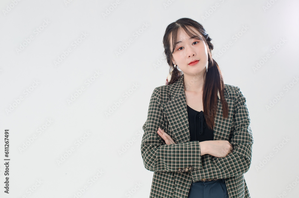 Portrait isolated cutout studio shot of Asian young cute female fashion model with pigtails braids hairstyle in casual plaid suit and crop top shirt standing posing look at camera on white background