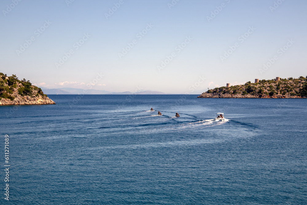 Speedboats accelerating out of a bay in the Ionian