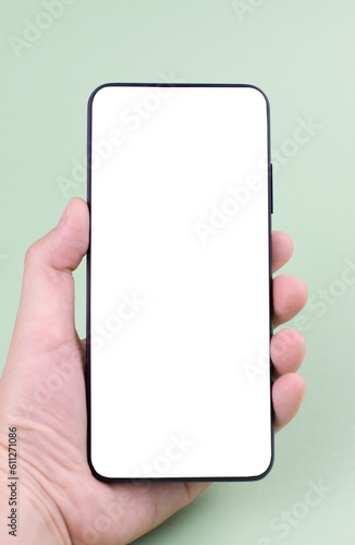 Phone in the hand on a green background