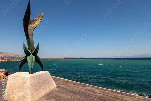 Modern Bronze statue in the Port of Chios, Greece photo