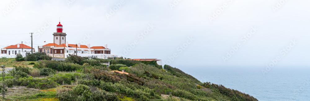 Famous tourist attraction the westernmost point of the Europe where tourists walk and take pictures.View near of Cabo da Roca lighthouse. Majestic coastline looking the Atlantic Ocean