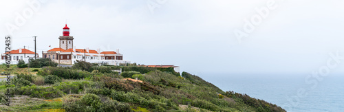 Famous tourist attraction the westernmost point of the Europe where tourists walk and take pictures.View near of Cabo da Roca lighthouse. Majestic coastline looking the Atlantic Ocean