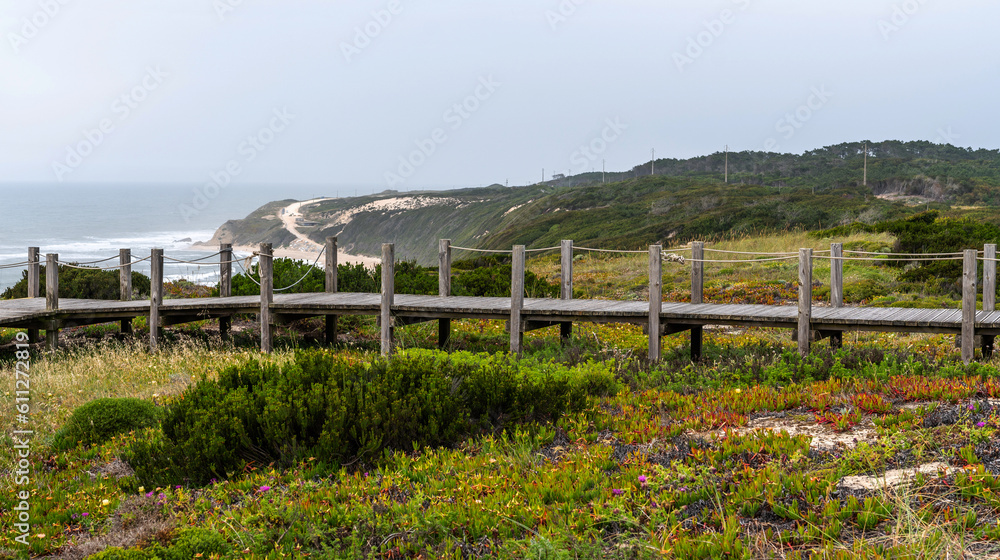 Majestic coastline looking the Atlantic Ocean. View of nature landscape shore. Wooden walkway to the beach, Portugal. Majestic coastline looking the Atlantic Ocean. View of nature landscape shore. Wooden walkway to the beach, Portugal.