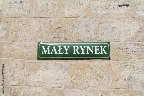 Mały Rynek street name sign in the Old Town district of Krakow, Poland. Information plate on building wall in Kraków. Little Market or the Small Square of Cracow. © Longfin Media