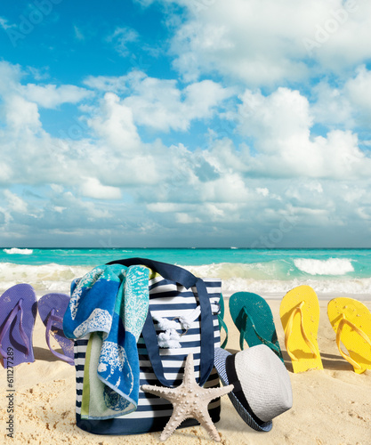 Beach scene with towel, bag, and shoes