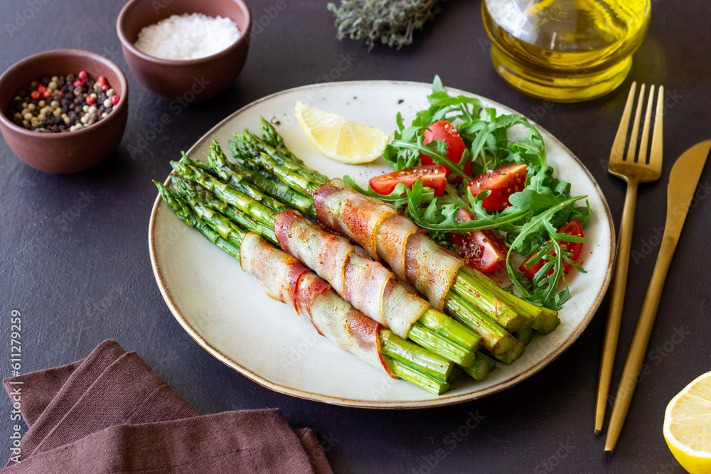 Asparagus baked with bacon and arugula and tomato salad. Healthy eating. Diet. Asparagus baked with bacon and arugula and tomato salad. Healthy eating. Diet.