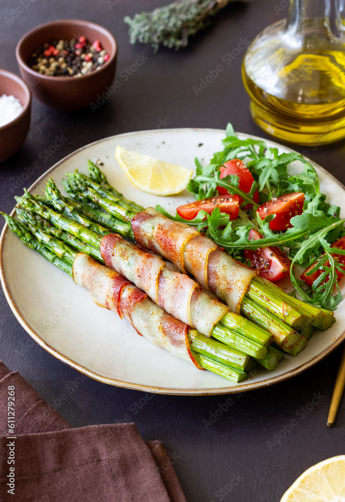 Asparagus baked with bacon and arugula and tomato salad. Healthy eating. Diet. Asparagus baked with bacon and arugula and tomato salad. Healthy eating. Diet.