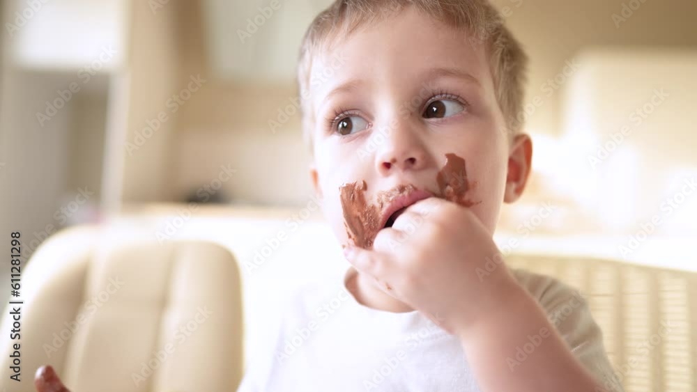 baby boy eat chocolate. dirty little baby kids in the kitchen eating chocolate in the morning. happy family eating sweets kid dream concept. baby dirty face eating lifestyle chocolate cocoa baby boy eat chocolate. dirty little baby kids in the kitchen eating chocolate in the morning. happy family eating sweets kid dream concept. baby dirty face eating lifestyle chocolate cocoa