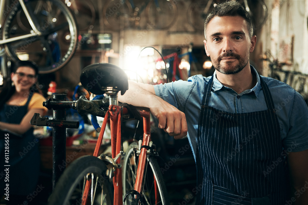 Serious, portrait and technician man in bicycle shop working in store or cycling workshop for repair. Face, bike mechanic and confident male person, business owner or mature professional with pride