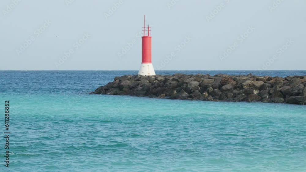Navigation beacon on a stone breakwater. Navigation beacon on a stone breakwater.