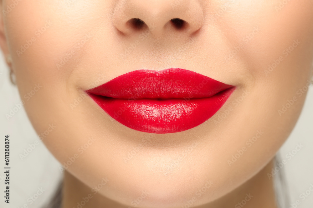Fototapeta premium Woman with red lipstick on light background, closeup