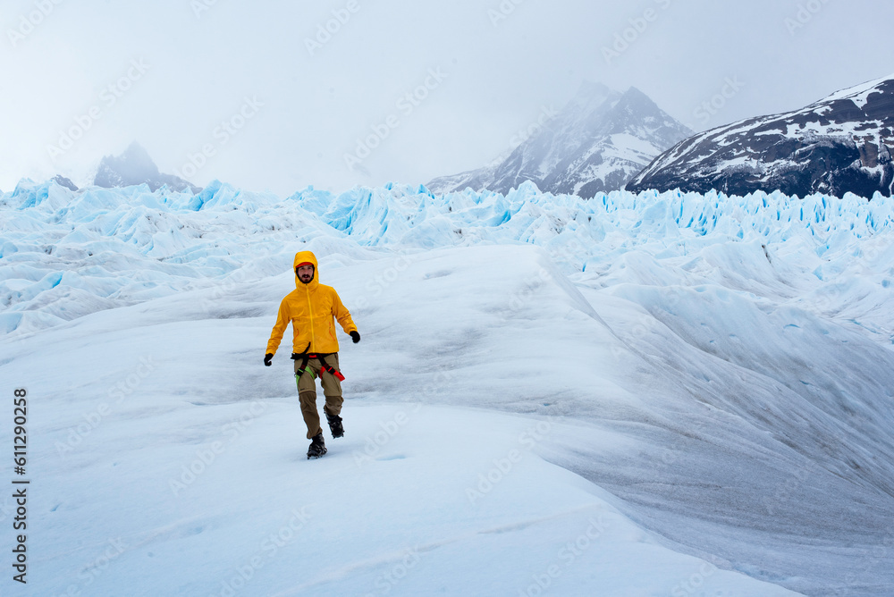 A man posing on the ice formation of the Perito Moreno glacier, Argentina A man posing on the ice formation of the Perito Moreno glacier, Argentina