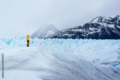 A man posing on the ice formation of the Perito Moreno glacier, Argentina © marina