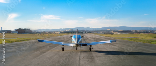 Blue single propeller plane prepared before takeoff on the empty runway of Sabadell airport on a sunny summer day