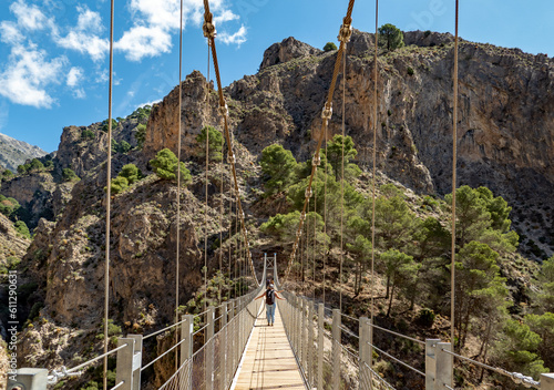 Famous suspension bridge on the Saltillo hiking trail near Canillas de Aceituno in Andalucia, Spain photo
