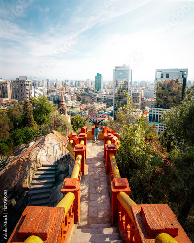 The tourist observes the impressive aerial views of downtown Santiago at the View Point of Santa Lucia Hill.