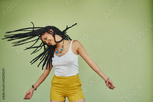 Happy, dance and freedom with black woman in studio for energy, natural and hip hop. Happiness, talent and culture with african female dancer on green background for mockup, motivation and crazy