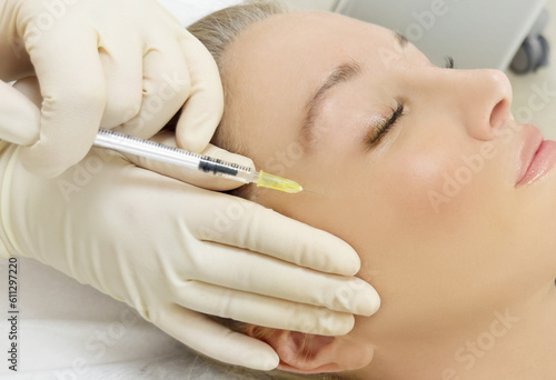 Botulinum toxin injection for facial wrinkles  ,in the therapy of mimic facial lines, non-invasive treatment for mimic facial wrinkles and neck and decollete lines.Cosmetic botulinum toxin injection photo